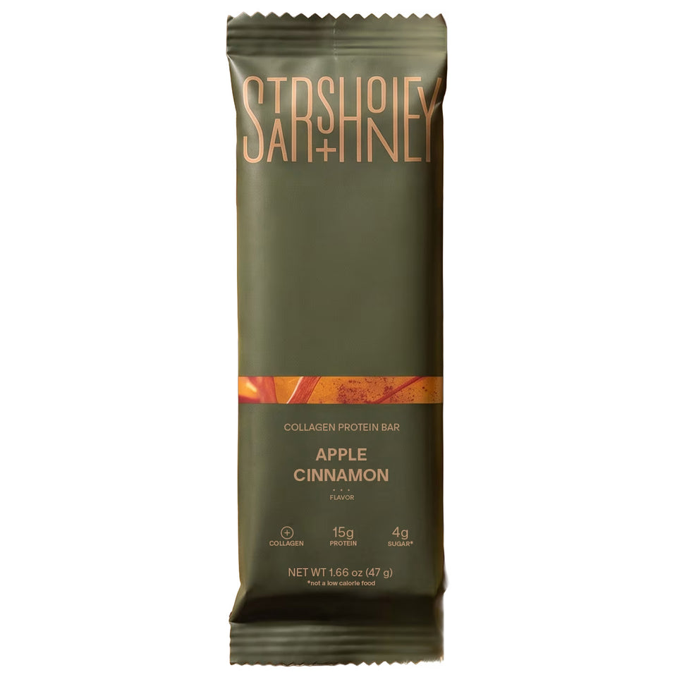 Stars + Honey Apple Cinnamon Collagen Protein Bar in a green wrapper on a white background.