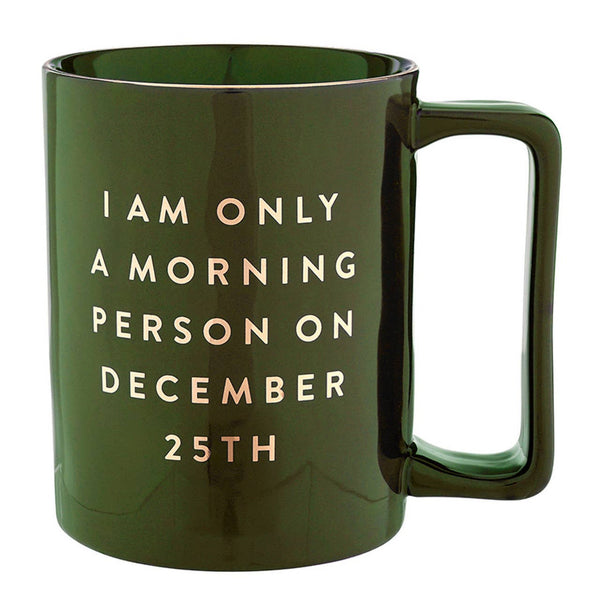 Green glass mug with gold text reading 'I am only a morning person on December 25th'