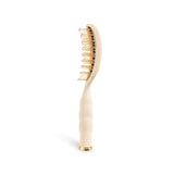 Tan vented hair brush with gold bristles and ergonomic handle on black background