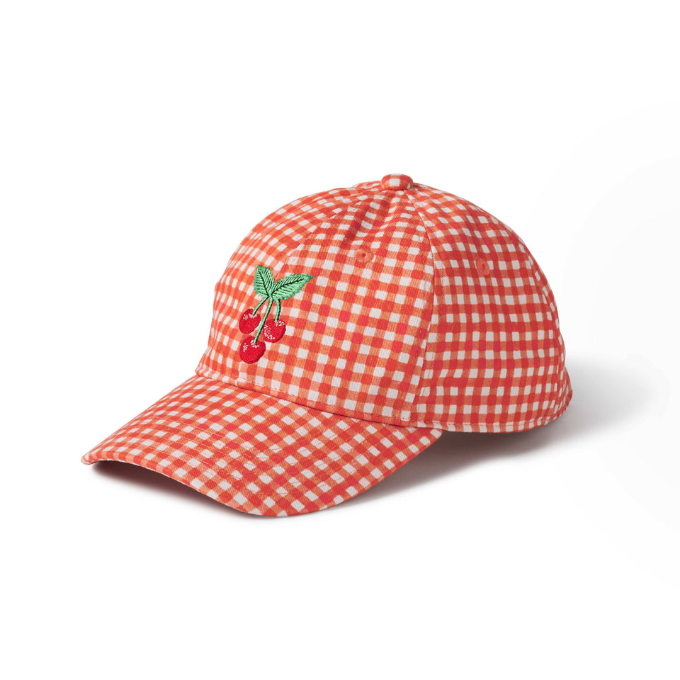 Red and white checkered cap with cherry design on a white background