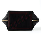KUSSHI | Vacationer Makeup Bag — Black/Red, A black nylon bag with red geometric stitching on the front flap and gold-tone metal zippers on both sides, shown against a plain white background.