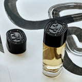 Diptyque 34 Boulevard Saint Germain fragrance bottle with 34 cap on a painted paper backdrop