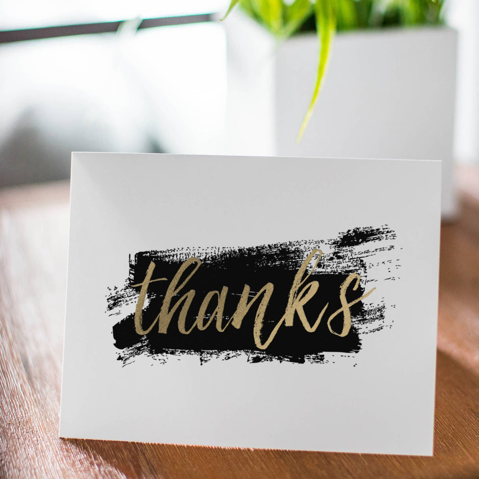 Brushstroke Gold Foil Thank You Card displayed on wooden surface with potted plant