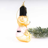 Gold and pink glass teddy bear Christmas ornament with black hat and gold glitter accents