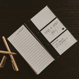 Portable sticky notes booklet displayed on dark wood with gold pen and clips, showing lined pages and 'have a great day' cover