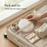 Travel mirror folded flat in beige case with accessories, demonstrating compact packing for trips