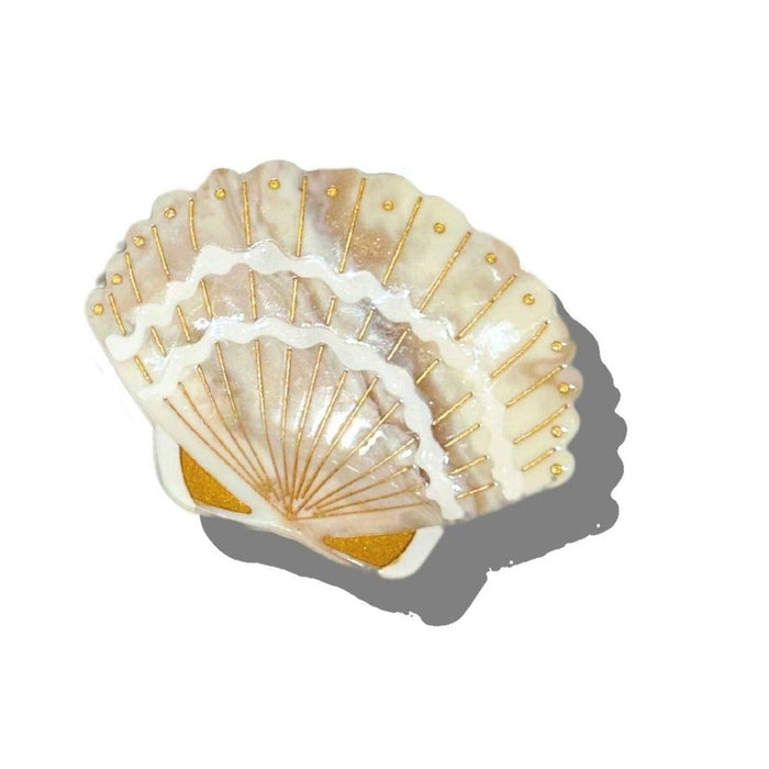 Solar Eclipse hand-painted seashell claw hair clip with gold accents on white background