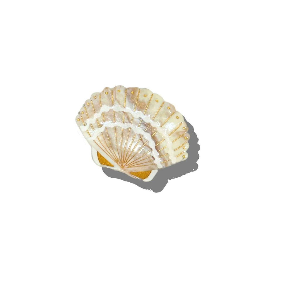 Solar Eclipse hand-painted seashell claw hair clip with gold accents on white background