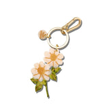 Hand-painted vintage daisy stem bag charm with gold keychain clip on white background