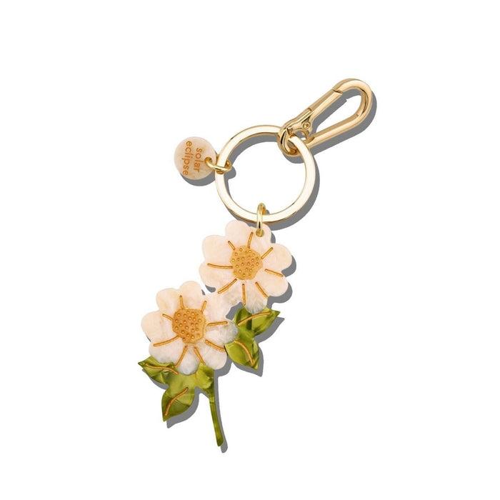 Hand-painted vintage daisy stem bag charm with gold keychain clip on white background