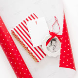 Christmas photo ornament displayed with red polka dot wrapping paper and festive decorations