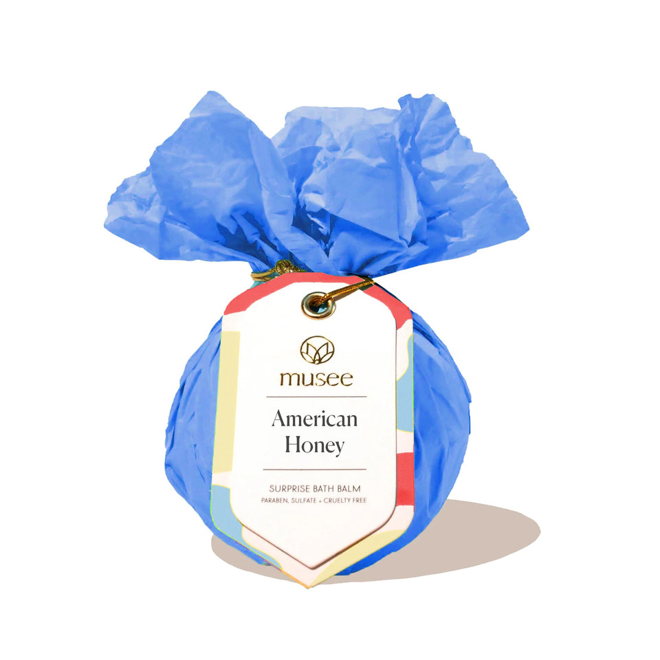 Musee American Honey Surprise Bath Balm wrapped in blue tissue with red ribbon bow