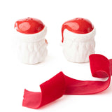 Red and white ceramic Santa salt and pepper shakers with red ribbon on white background