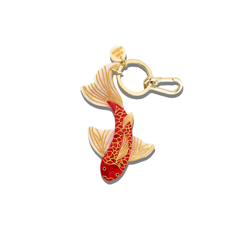Hand-painted red and gold koi fish bag charm with gold keychain clip on white background