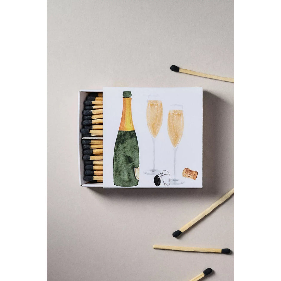 Champagne matches box with celebration design featuring bottle, glasses and cork illustration
