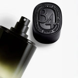 Diptyque 34 Boulevard Saint Germain Eau de Parfum bottle beside its black 34 cap
