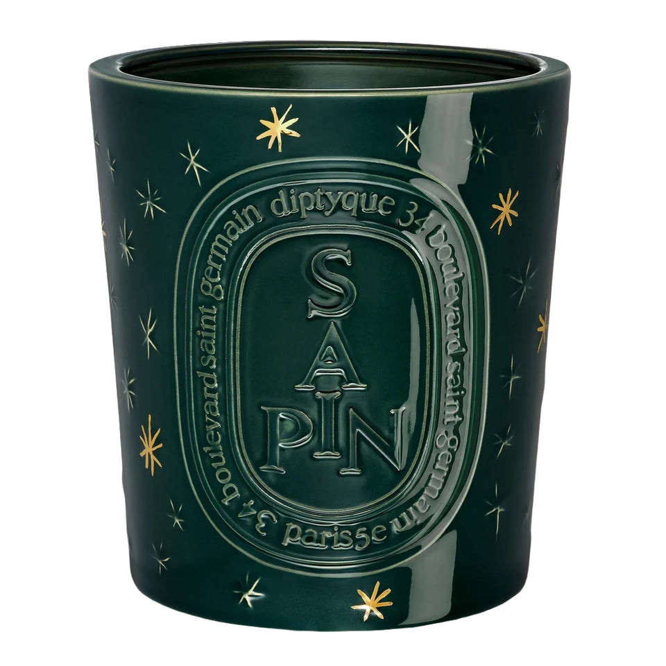 Diptyque Sapin very large candle in a deep green glazed ceramic vessel with gold stars