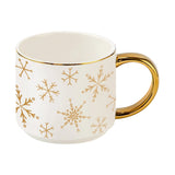Gold Snowflakes Coffee Mug with white ceramic body and gold handle on white background