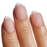 French manicure press-on nails with white tips on model's fingertips, showcasing classic salon look