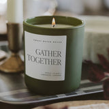Green soy candle labeled Gather Together with apple, clove, cinnamon, orange scents in styled home decor setting