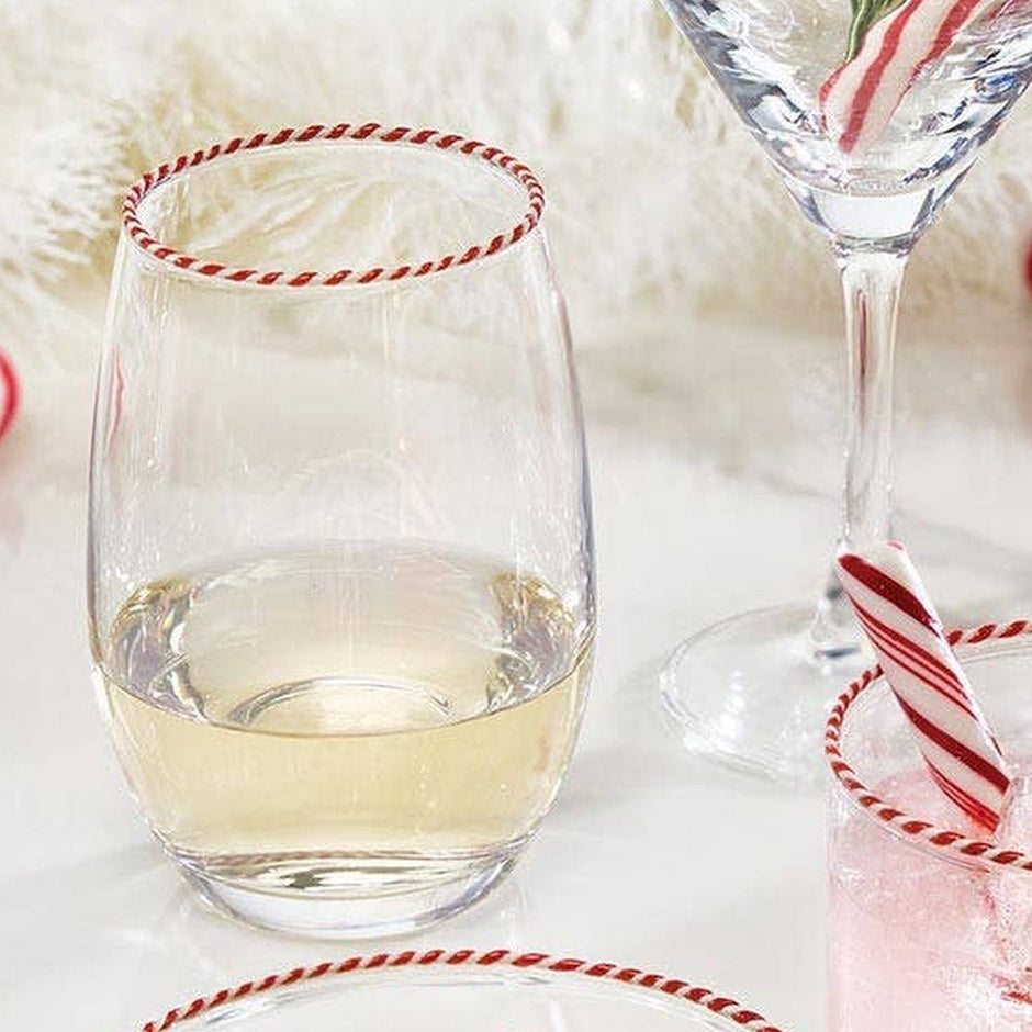 Peppermint Twist wine glasses with candy cane stirrers and peppermint candies in festive holiday setting