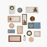 Collection of Rifle Paper Co. Christmas gift tags and labels featuring bears, wreaths, and holiday designs on neutral background.
