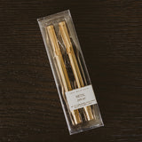 Gold Metal Pen Set with two ballpoint pens in clear packaging on dark wooden surface
