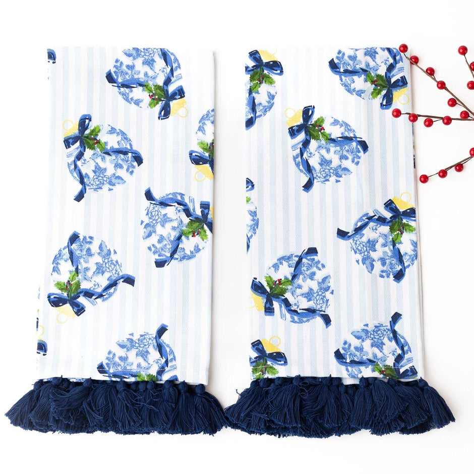 Blue and white chinoiserie patterned kitchen towels with navy tassel trim and holiday decoration