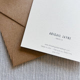 ABIGAIL JAYNE DESIGN greeting card displayed with kraft envelope and textured fabric on neutral background