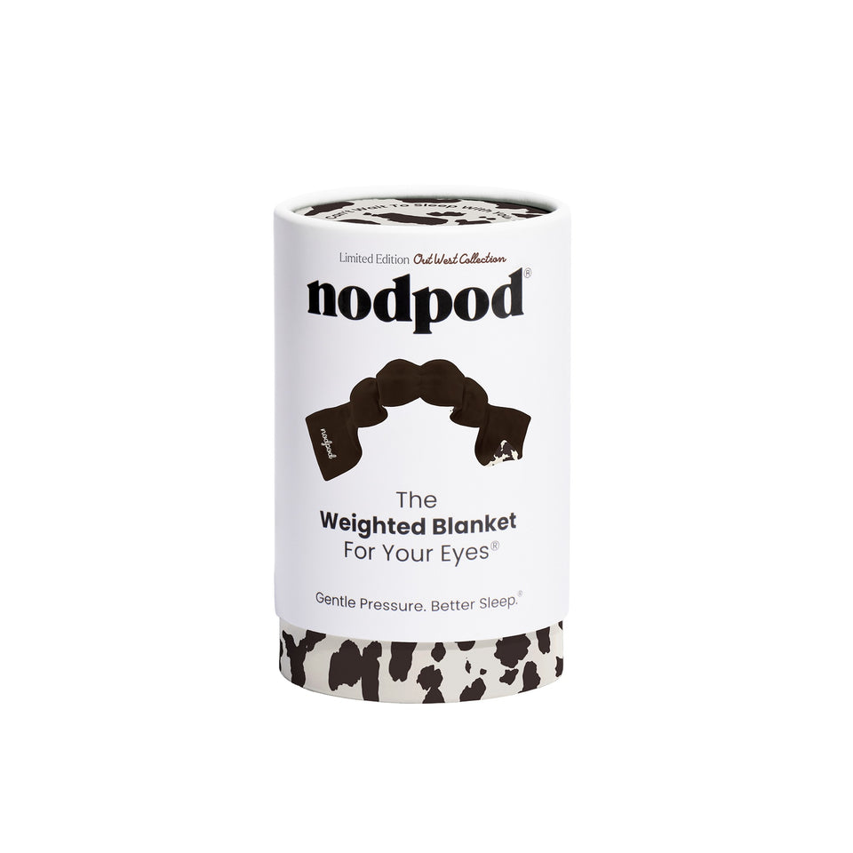 Nodpod cowhide weighted sleep mask in cylindrical packaging against white background