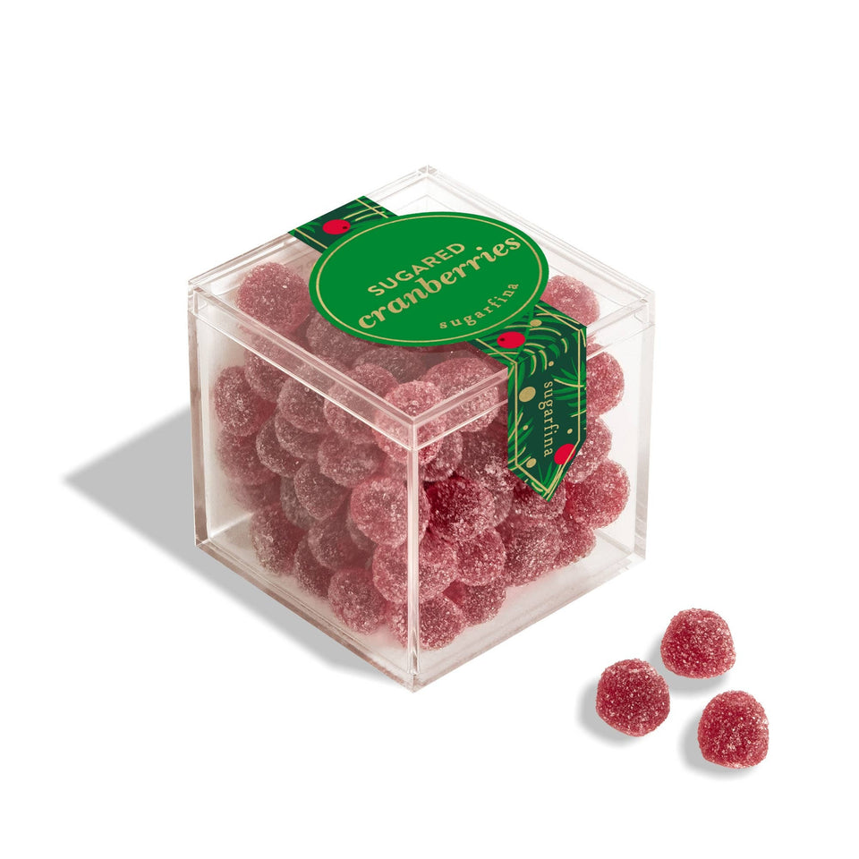 Clear cube box of Sugarfina sugared cranberries with green label, three candies displayed in front