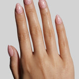 Extra short almond nails with pink Angel Glaze Dot manicure design on model hand