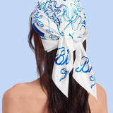 Woman wearing white and blue floral bride hair scarf for wedding and bachelorette events