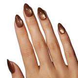 Cinnamon Powder Press On Nails in almond shape with glitter finish worn on model hand
