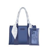 Navy blue Casemate tote bag with floral patterned handles and matching phone case attached