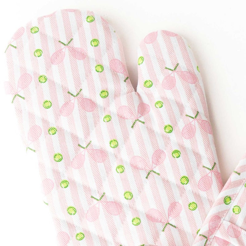 Pink tennis stripe oven mitt set with green citrus pattern on white background