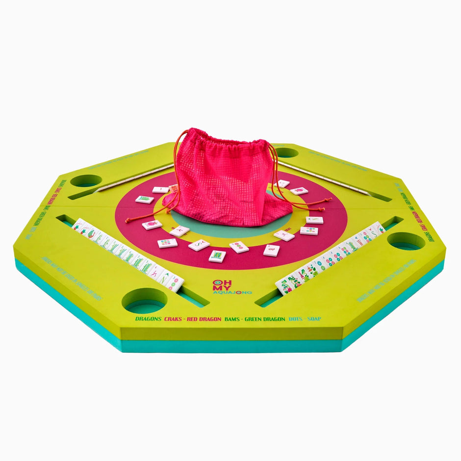 Colorful board game with a pink drawstring bag on a white background