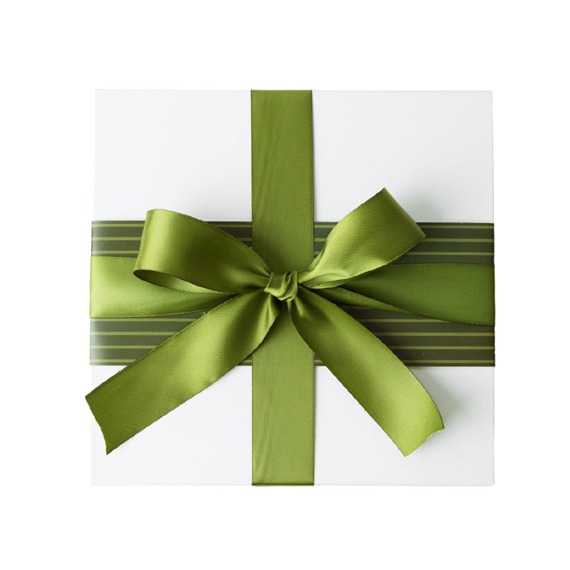 Gift box with a green ribbon and a light and dark green striped sleeve on a white background