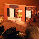Hand holding the open Pecan Pie Latte Mixer Kit above a plate of desserts