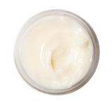 Top-down view of the pale, creamy Dream Slip lip mask swirled inside an open jar