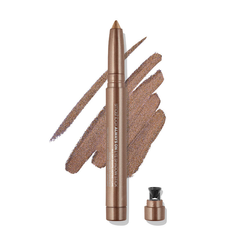 Bronze-colored eyeliner pencil with applicator on a white background