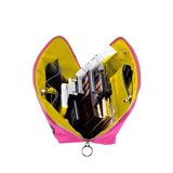 KUSSHI | Vacationer Makeup Bag — Flamingo Pink/Sunshine Yellow, A bright pink zippered cosmetic bag shown open from above, filled with various makeup items and accessories against a plain white background.